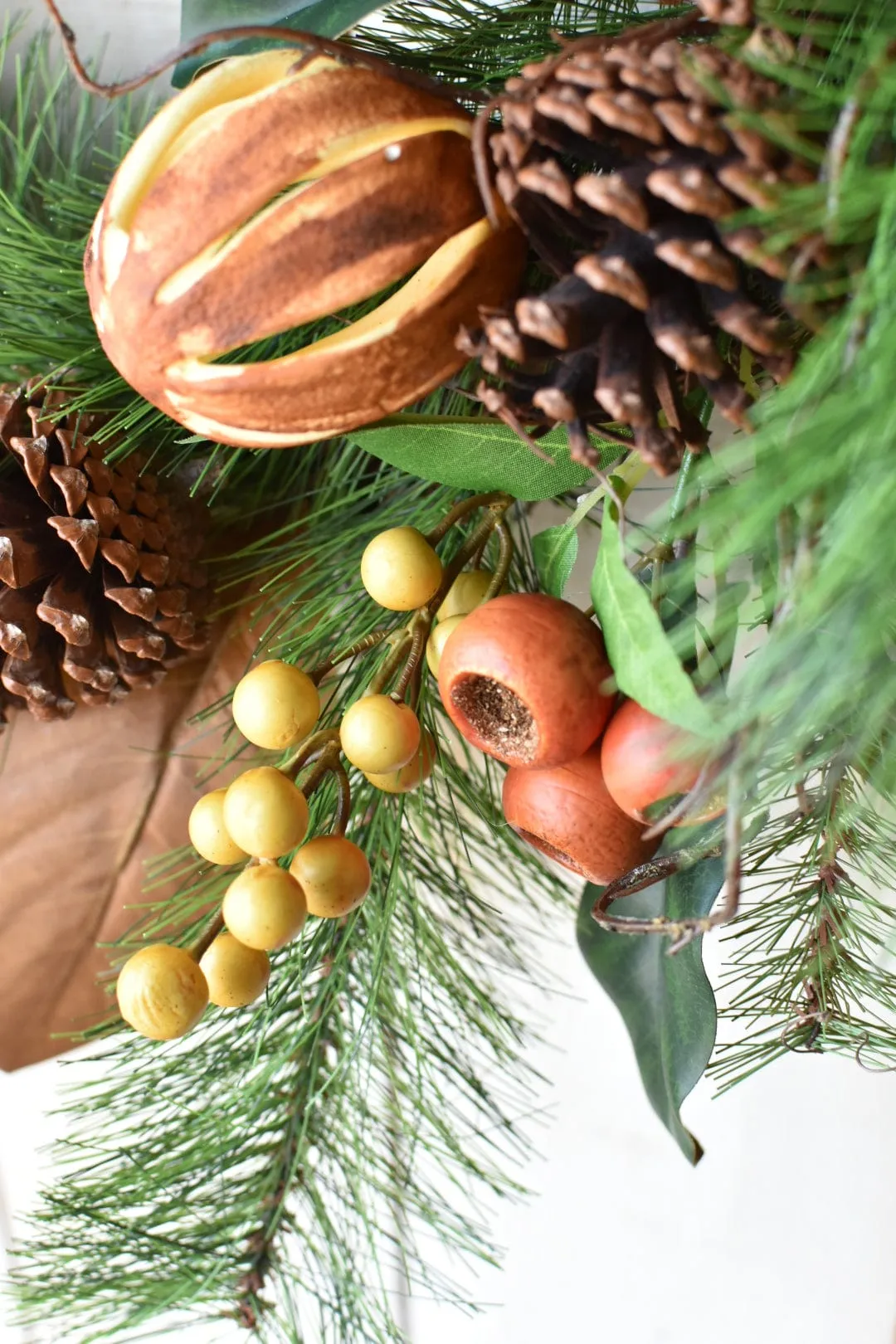 24" Faux Mixed Pine, Magnolia, Orange, and Berry Wreath